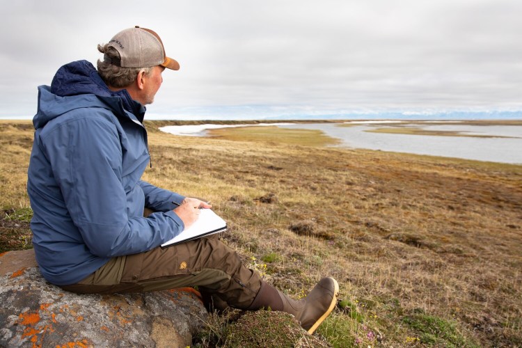 Wildlife artist Michael Boardman of North Yarmouth sketches on the tundra in the Arctic National Wildlife Refuge, where he served as artist in residence for 10 days in June. "It’s so terrible to destroy this place in any way, shape or form," he said.