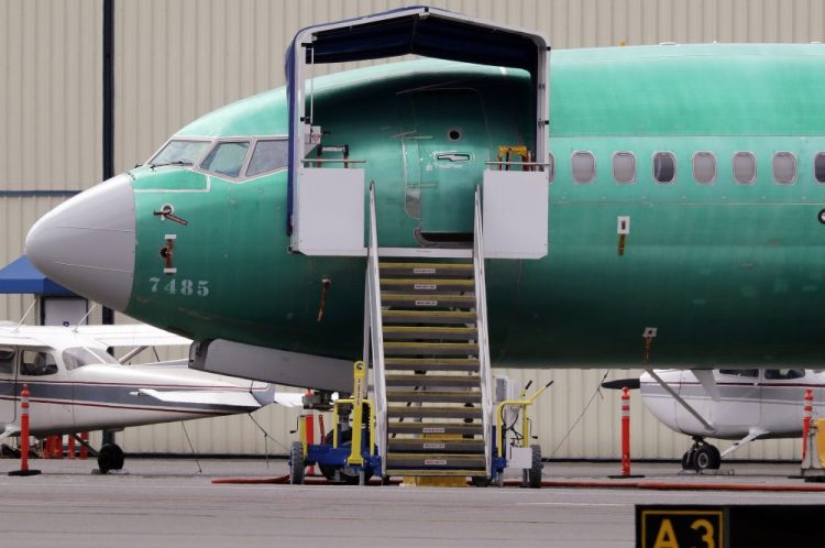 In this April 8, 2019, file photo a Boeing 737 MAX 7 jet is parked near single engine planes at the airport adjacent to a Boeing Co. production facility in Renton, Wash. 