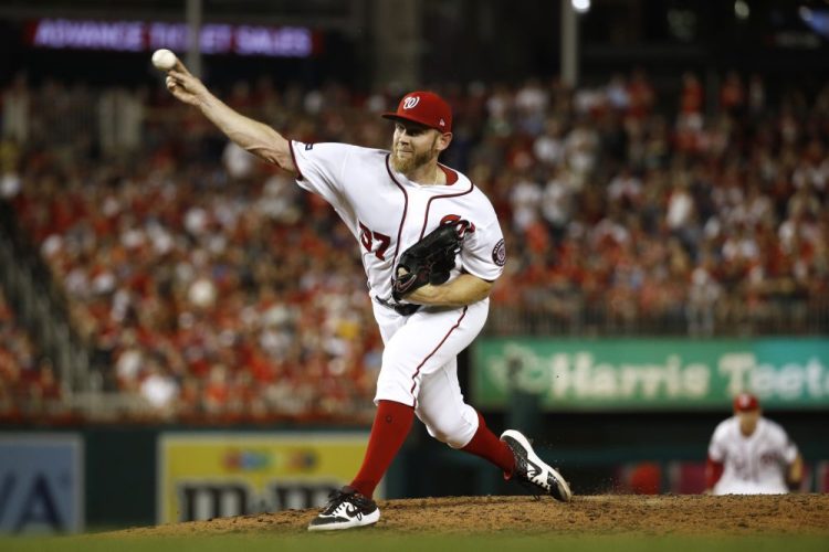 Washington Nationals relief pitcher Stephen Strasburg throws to the Milwaukee Brewers in the sixth inning Tuesday night in Washington. The Nationals erased a two-run deficit in the eighth inning to win.
