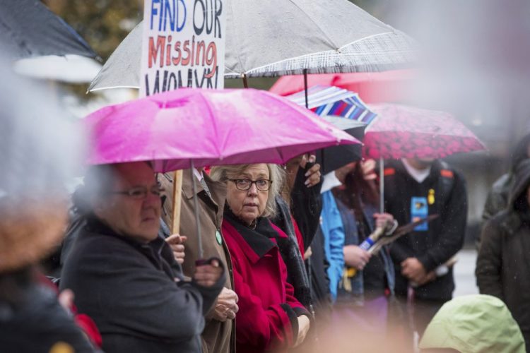Green Party leader Elizabeth May listens to speeches before participating in a march calling for justice for missing and murdered Indigenous women and girls Sunday in Vancouver, British Columbia.