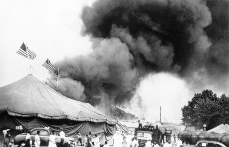 People flee a fire in the big top of the Ringling Brothers and Barnum & Bailey Circus in Hartford, Conn., on July 6, 1944. Authorities are exhuming the bodies of two victims in hopes of identifying a Vermont woman who has been missing since then.