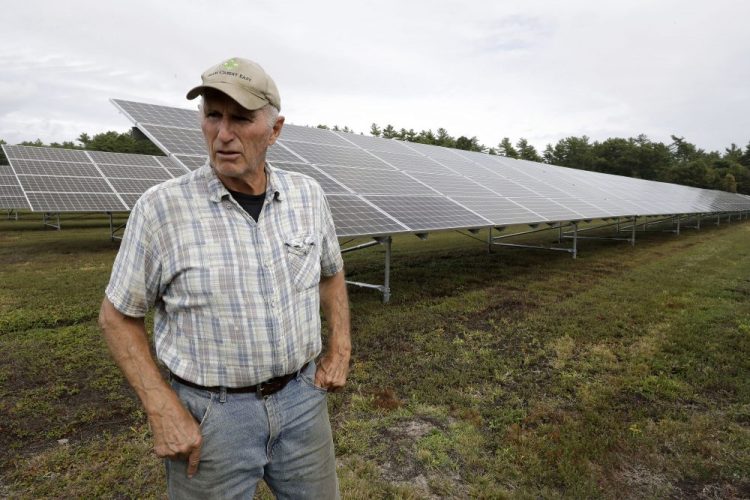 Cranberry grower Dick Ward, of Carver, Mass., stands near a solar array in a cranberry bog on his farm in Carver this month. The revenue that solar power offers has been helpful to farmers as the price of cranberries has dipped in recent years.