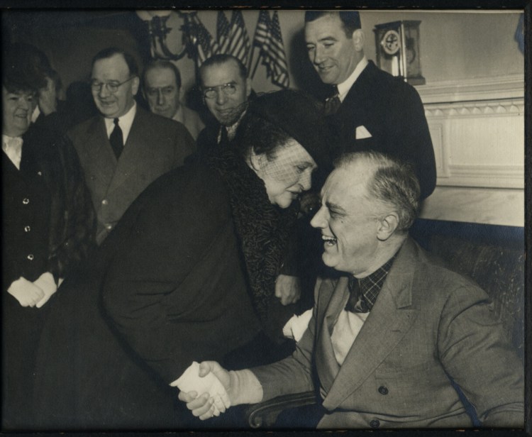 Frances Perkins, left, laughing with Franklin Delano Roosevelt.