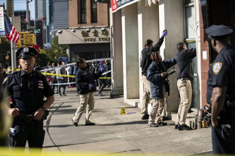 Police investigate the scene of an attack in Manhattan's Chinatown neighborhood Saturday, in New York. 


