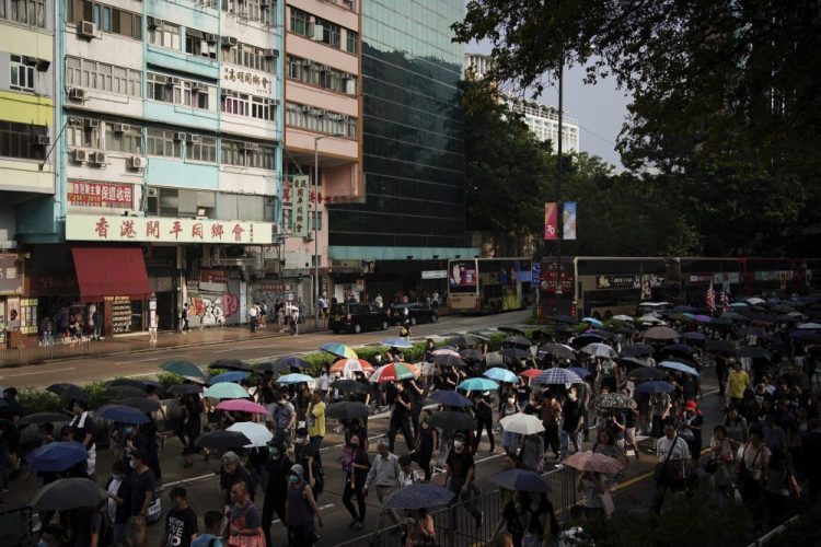 Protesters march in Hong Kong on Saturday. The protests that started in June over a now-shelved extradition bill have since snowballed into an anti-China campaign amid anger over what many view as Beijing's interference in Hong Kong's autonomy that was granted when the former British colony returned to Chinese rule in 1997. 