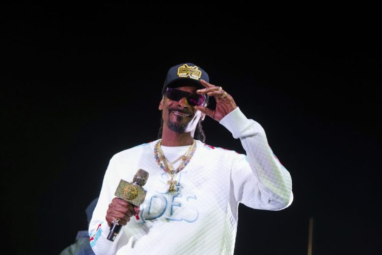 Snoop Dogg's performance at the University of Kansas' basketball kickoff included pole dancers and fake money shot over recruits' heads.