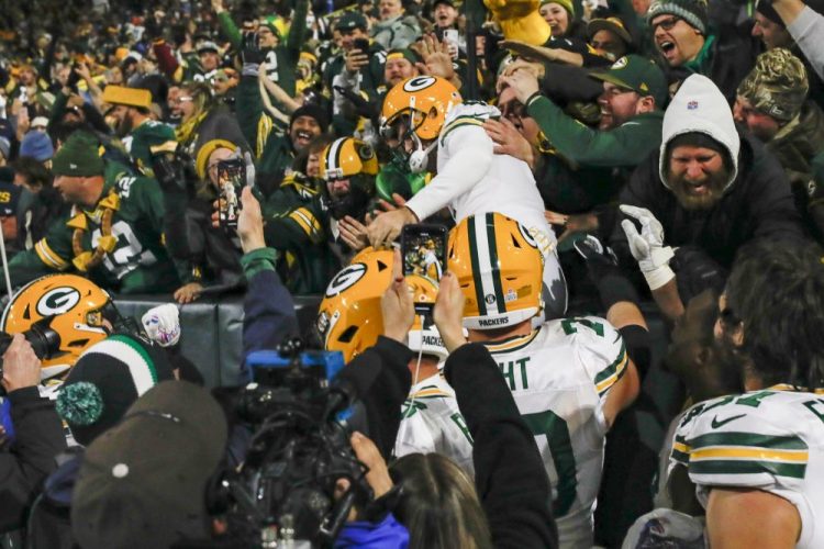 Green Bay kicker Mason Crosby celebrates kicking the game-winning field goal by jumping in the stands . The Packers defeated the Lions, 23-22. 