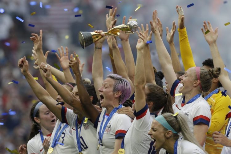 In this July 7, 2019, file photo, U.S. player Megan Rapinoe holds the trophy after winning the Women's World Cup final soccer match against The Netherlands at the Stade de Lyon in Decines, outside Lyon, France. 