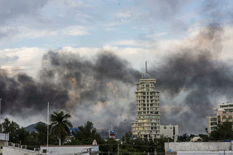 Smoke from burning cars rises in Culiacan, Mexico, on Thursday. An intense gunfight with heavy weapons and burning vehicles blocking roads raged in the capital of Mexico’s Sinaloa state after security forces located one of Joaquín “El Chapo” Guzmán’s sons, who is wanted in the U.S. on drug trafficking charges.