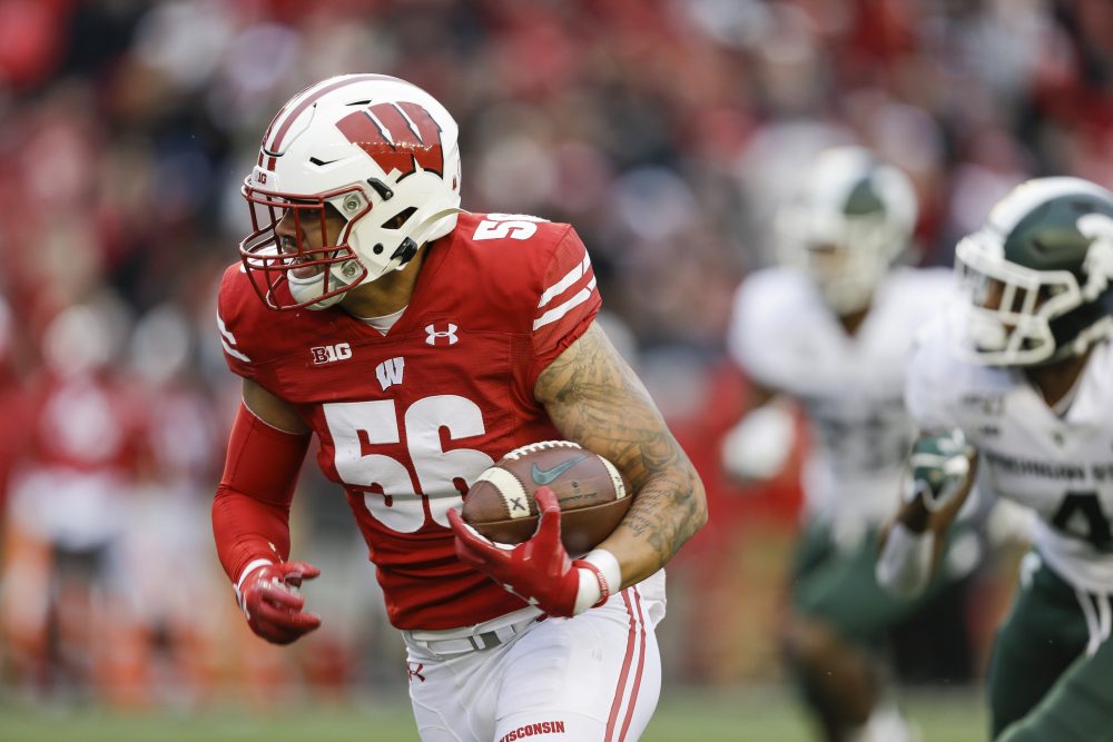 Wisconsin linebacker Zack Baun (56) returns an interception for a touchdown against Michigan State wide receiver C.J. Hayes (4) during the second half of an NCAA college football game Saturday, Oct. 12, 2019, in Madison, Wis. Wisconsin won 38-0. (AP Photo/Andy Manis)