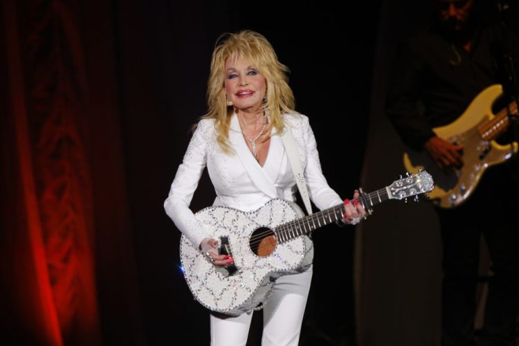 In this July 31, 2015 file photo, Dolly Parton performs in concert at the Ryman Auditorium in Nashville, Tenn. Parton will perform a new song “Faith” in a gospel medley at the Country Music Association Awards  on the Nov. 13 awards show in Nashville, Tenn.  