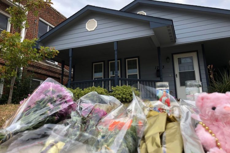 Bouquets of flowers and stuffed animals are piled up outside the Fort Worth home Monday where a 28-year-old black woman was shot to death by a white police officer. 