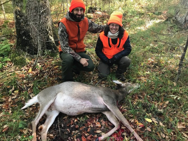 Rebecca Happnie-Yoder, right, proudly shows off the first deer she shot with her husband, Jordan Yoder, at Maine's first mentor hunt, held on Oct. 5 on Swan Island in Richmond. The mentor hunt was part of the state's efforts to encourage new hunters. 