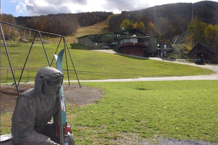 A sculpture of a skier and slopes, rear, await the ski season Wednesday at Sugarbush Resort in Warren, Vt. In the tight labor market, ski areas are having a tough time hiring seasonal workers so they're upping the ante by boosting wages, offering more worker housing and other incentives.