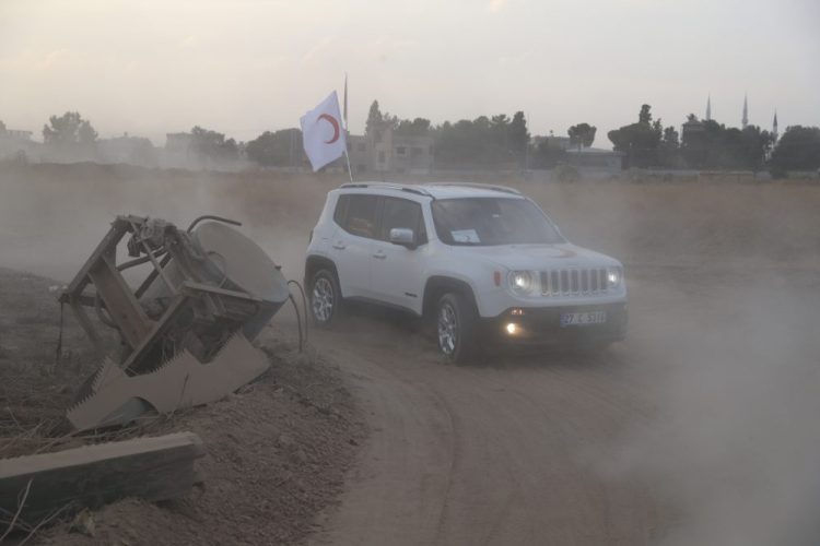 Turkish Red Crescent vehicles arrive to deliver aid to Syrians in Ras Al-Ain, Syria, on Saturday. The city was evacuated on Sunday, a spokesman for the Kurdish-led Syrian Democratic Forces said. 