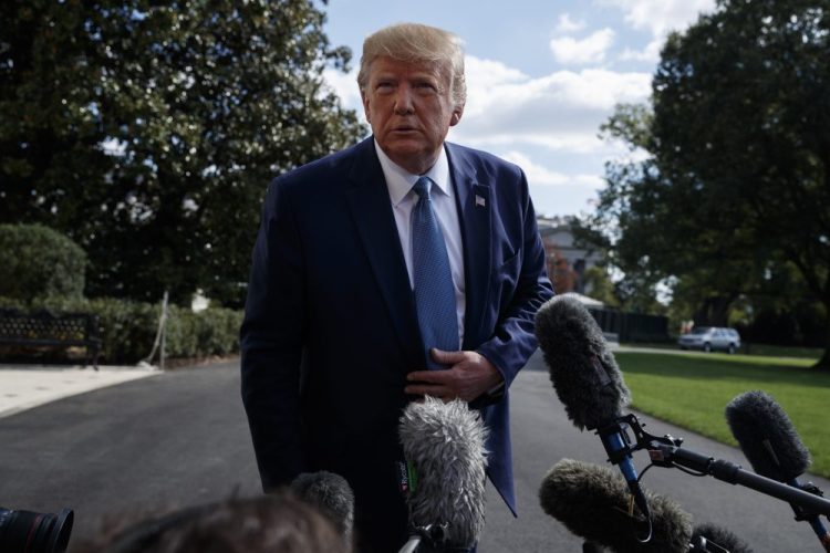 President Trump talks to reporters on the South Lawn of the White House on Friday. The president's call for China to investigate Joe Biden added a fresh layer of controversy to Democrats' impeachment inquiry.