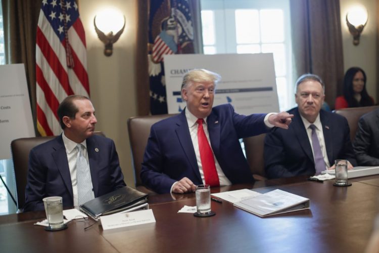 President Trump, center, points to members of his Cabinet while speaking during a Cabinet meeting Monday in the Cabinet Room of the White House, as Health and Human Services Secretary Alex Azar, left, and Secretary of State Mike Pompeo, right, listen.