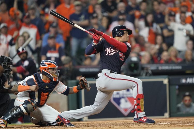 The Washington Nationals' Juan Soto hits a two-run double in the fifth inning of Game 1 of the World Series on Tuesday night in Houston. Soto powered Washington to a 5-4 win, driving in three runs.
