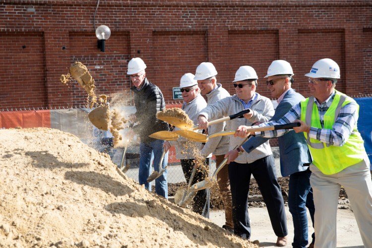Developers and others break ground on a new hotel on Commercial Street in Portland on Friday. From left, are Greg Mitchell, city of Portland; Dennis Ruppel, Jim Brady and Chris Ruppel from Fathom Cos.; Gary Steffen, Canopy by Hilton; and Jonathan Dicentes, Cianbro Corp. The hotel is slated to open in the spring of 2021. 