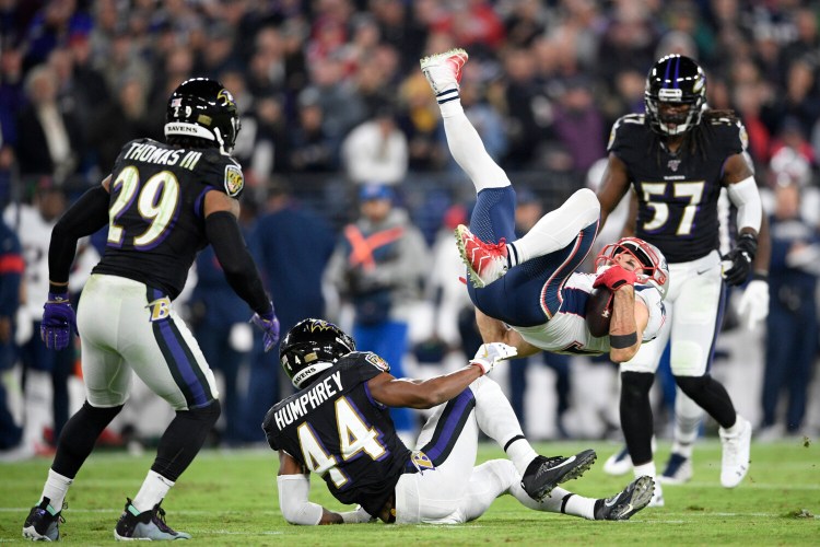 Julian Edelman and the New England Patriots were upended by Marlon Humphrey, center, and the Baltimore Ravens on Sunday night. 
