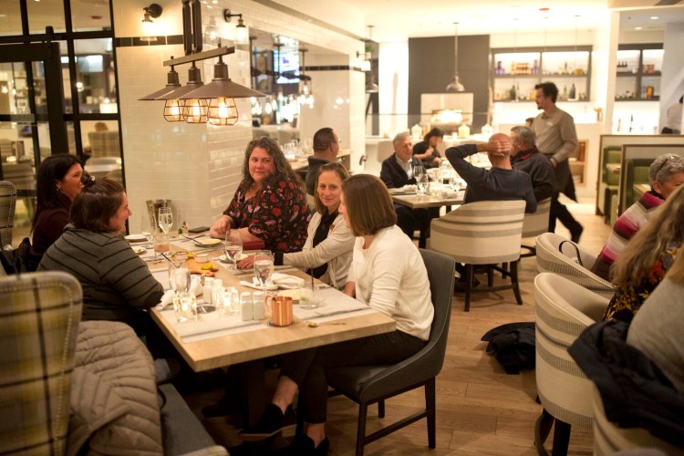 SOUTH PORTLAND, ME - NOVEMBER 14: From left, (right side of the table) Jaime Hyatt, Andrea Ernst and Elizabeth Lupien have dinner with friends at City Farmhouse Kitchen & Bar on Thursday, November 14, 2019. The new restaurant inside the Portland Sheraton at Sable Oaks opened over the summer. (Staff Photo by Brianna Soukup/Staff Photographer)