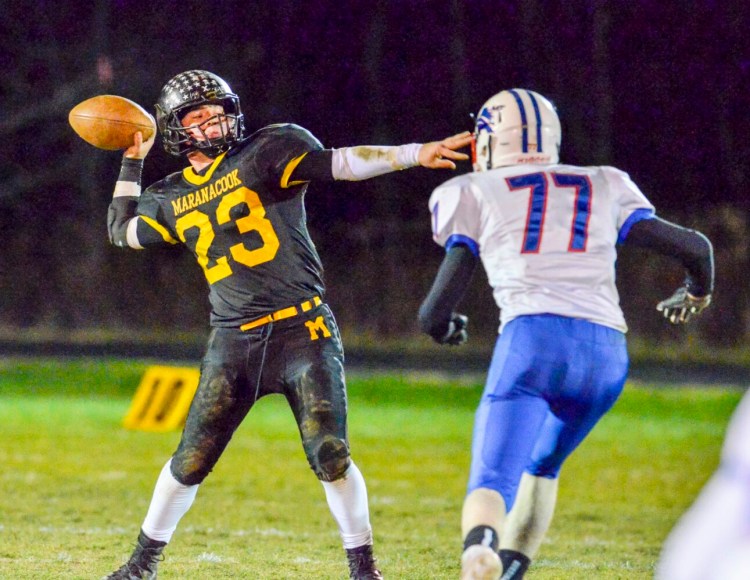 Maranacook quarterback Garit Laliberte, left, throws a pass in front of Mt. Ararat defender Damien Weed during the eight-man large school championship game earlier this season at the Ricky Gibson Field of Dreams in Readfield. 