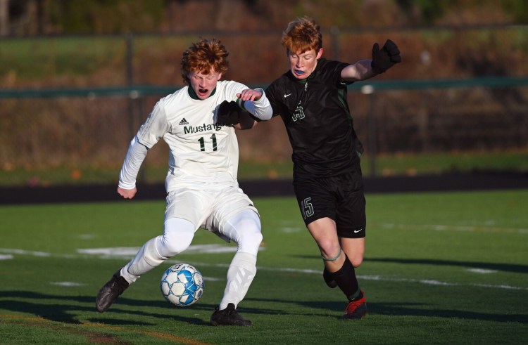 Mount View's Elijah Allen (11) battles for the ball with Waynflete's Roan Hopkins in the Class C state championship Saturday in Falmouth.