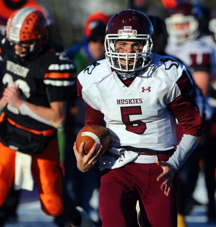 MCI quarterback Ryan Friend races ahead of Winslow defenders to score a touchdown during the Class C North final earlier this season in Hampden.