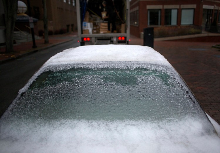 A parked car is encased in ice after freezing rain coated Portland overnight and into the morning on Tuesday. Much of Maine got much worse, but a cold-weather record was set at the Portland International Jetport, where the high temperature for Tuesday was just 33 degrees.