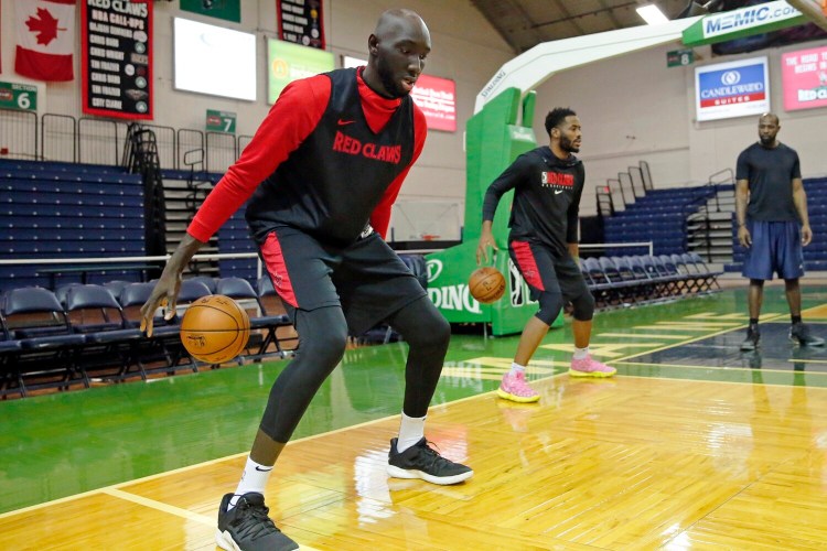 Tacko Fall, left, and Yante Maten work on dribbling skills on Thursday at Portland Expo.