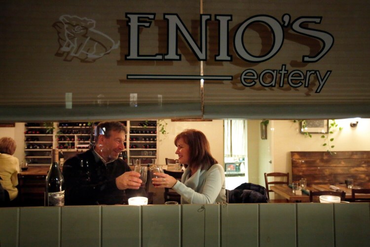 David Turgelsky, left, and Tina Crellin of Cape Elizabeth dine at a window seat at Enio's, the sort of neighborhood restaurant everybody wishes were in their own neighborhood.