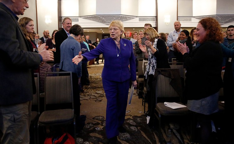 Gov. Janet Mills shakes hands with attendees before delivering opening remarks Monday at the Gulf of Maine 2050 International Symposium at the Westin Portland Harborview. Mills has set a goal of reducing Maine’s greenhouse gas emissions by 80 percent from 1990 levels by 2050.