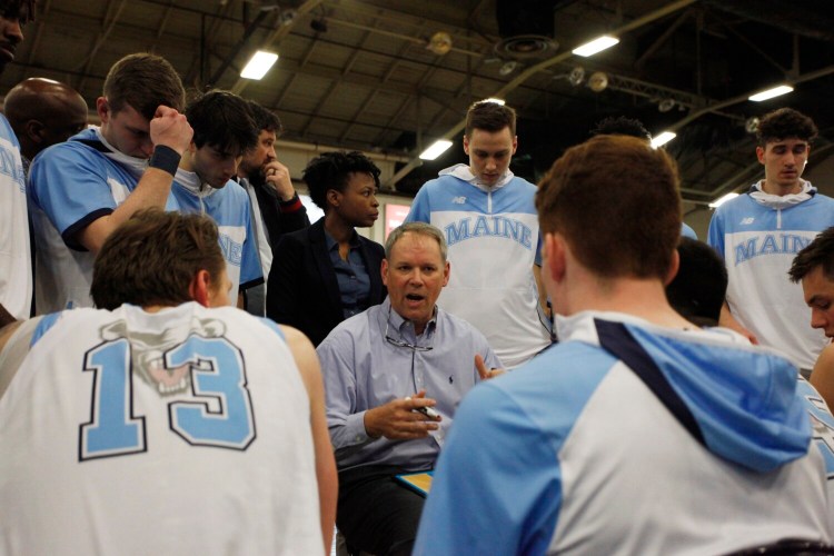 Maine men's basketball coach Richard Barron talks to his team before a game last year against Maine Maritime at the Portland Expo. 