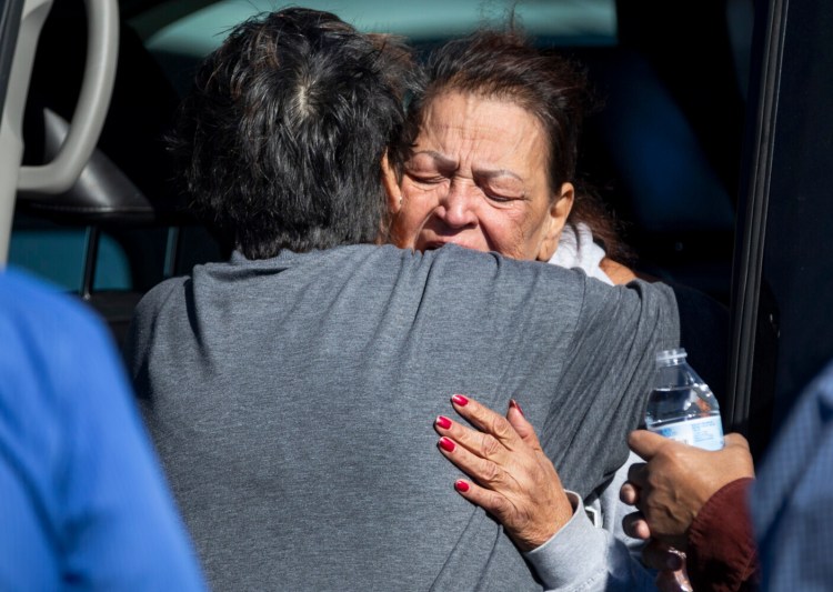 A family member reacts at the scene of a fatal shooting in the parking lot of a Walmart in Duncan, Okla., on Monday. 