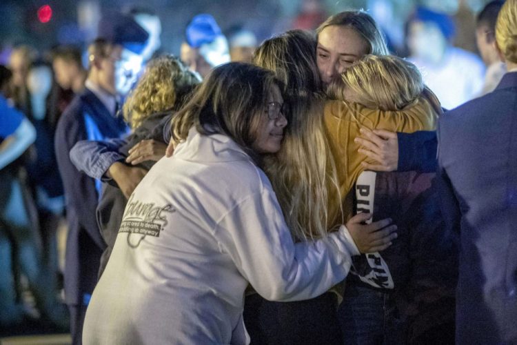 People hug each other during a vigil for the Saugus High School shooting victims at Central Park, Thursday, Nov. 14, 2019, in Santa Clarita, Calif. Los Angeles County sheriff’s officials say a 16-year-old student shot several classmates and then himself in a quad area of Saugus High School Thursday morning. (Hans Gutknecht/The Orange County Register/SCNG via AP)