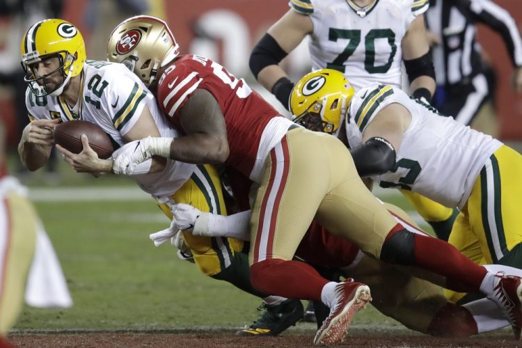 Green Bay Packers quarterback Aaron Rodgers is sacked by San Francisco 49ers defensive tackle DeForest Buckner.