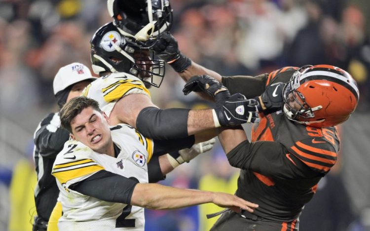 Cleveland Browns defensive end Myles Garrett hits Pittsburgh quarterback Mason Rudolph with a helmet in a game on Nov. 14, 2019, in Cleveland. 
