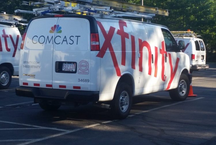 Comcast trucks are parked in a lot in the company's Westford, Massachusetts, headquarters. Comcast and several other cable companies are challenging a new Maine law that would allow customers to choose only the cable stations they want, rather than accepting prepackaged bundles.
