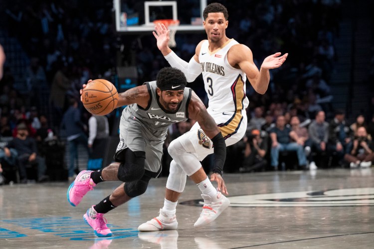 Nets guard Kyrie Irving drives to the basket against Pelicans guard Josh Hart on Monday in New York. Irving scored 39 points and Brooklyn won 135-125.
