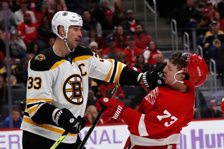 Boston  defenseman Zdeno Chara, left, pushes Detroit left wing Adam Erne during the second period of Friday's game in Detroit. 