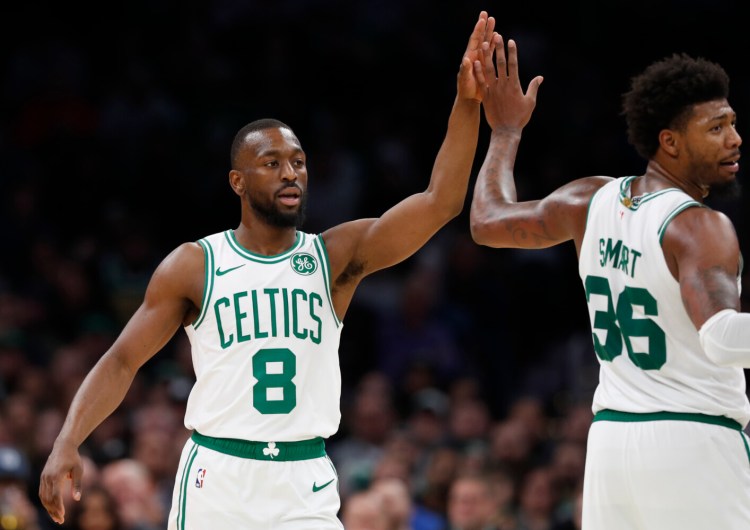 Boston Celtics' Kemba Walker high-fives with Marcus Smart during the fourth quarter Wednesday night against the Washington Wizards.