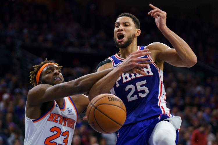 Ben Simmons, right, reacts to being fouled by New York's Mitchell Robinson, during the second half of Philadelphia's win over the visiting Knicks. 