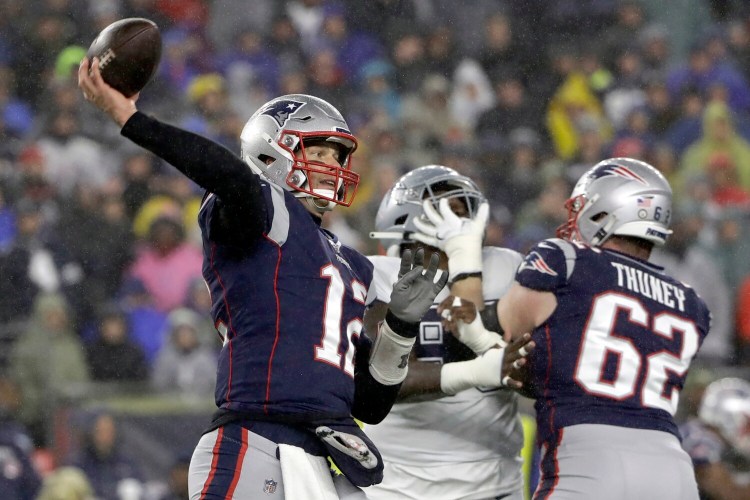 New England Patriots quarterback Tom Brady passes behind a block by guard Joe Thuney against the Dallas Cowboys on Sunday in Foxborough, Mass. 