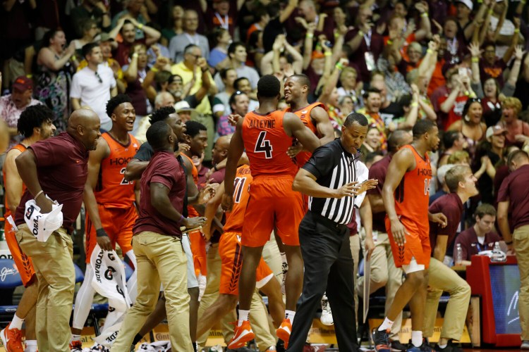 The Virginia Tech bench and fans react after the Hokies' win over No. 3 Michigan State on Monday in Lahaina, Hawaii. 