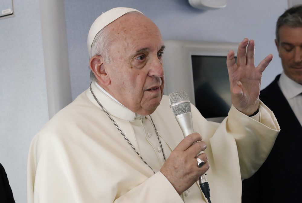Pope Francis speaks during a news conference onboard the papal plane on his flight back from a trip to Thailand and Japan
