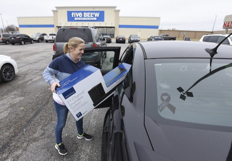 Gena Johnson loads a sound-bar system that she bought on Black Friday at Best Buy in Owensboro, Ky. Thirty-nine percent of Black Friday shopping happened on people's phones.