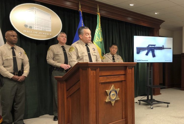 Los Angeles County Sheriff Alex Villanueva, at the podium, talks Friday about the arrest of a 13-year-old boy and the seizure of a rifle and ammunition.

