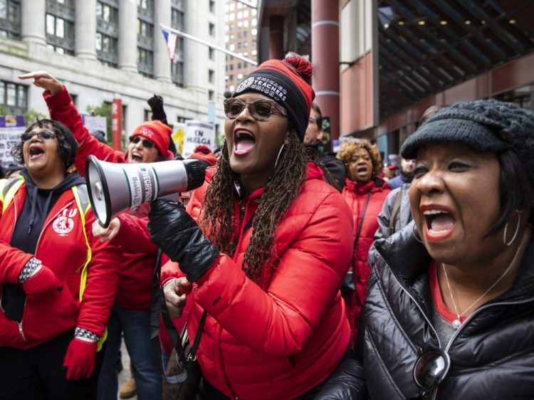 Thousands of striking Chicago Teachers Union and their supporters rally at the Thompson Center in downtown Chicago. Chicago teachers have voted in favor of the contract deal that ended an 11-day strike. The Chicago Teachers Union announced the results late Friday.