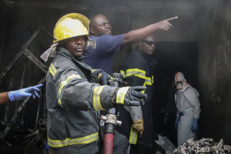 Rescuers attend the scene of an aircraft operated by private carrier Busy Bee which crashed in Goma, Congo on Sunday. The plane carrying at least 17 passengers crashed Sunday on takeoff.