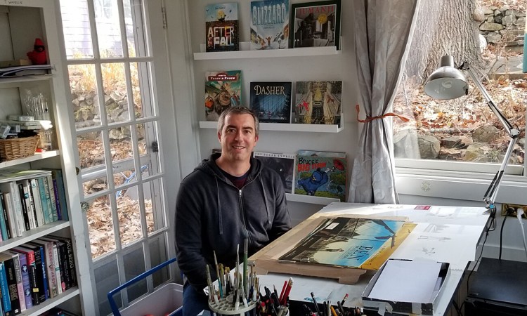 Matt Tavares, children's book author and illustrator, at his drafting table in his home in Ogunquit.